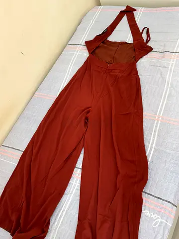 rust-colored, halter-neck wide-leg jumpsuit