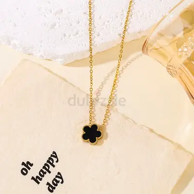 Gold-tone necklace with black clover pendant — delicate everyday piece