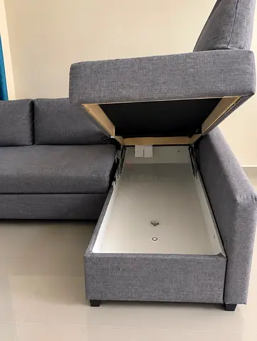 Grey L-shaped storage sofa with chaise, excellent condition.