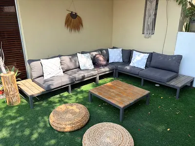 Outdoor L-shaped modular sofa set with coffee table and cushions