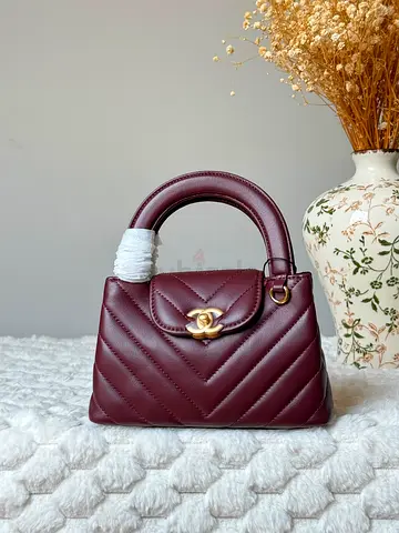 Maroon quilted top-handle handbag with gold-tone CC clasp