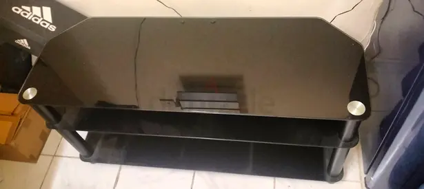 Black glass TV stand with shelves - good condition