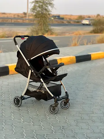 Lightweight black Babyhug stroller with canopy and storage basket