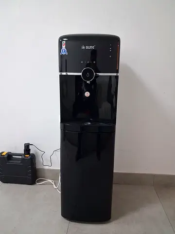 Black Sure Water Dispenser with Bottom Storage - Good Working Condition