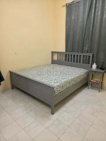 IKEA Grey wooden double bed frame with mattress and bedside table