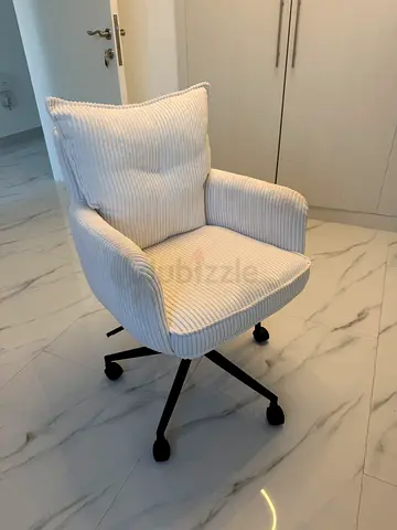 Comfortable white corduroy swivel office chair with cushion