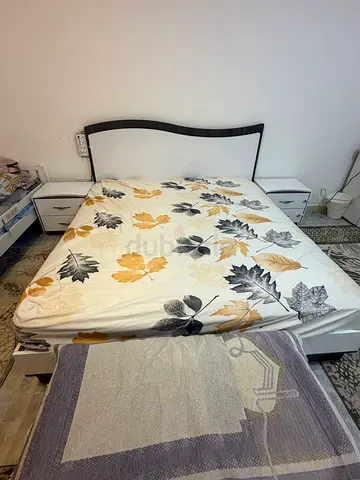 Queen bed frame with mattress and bedside tables - good condition