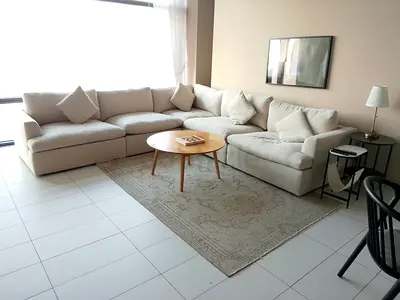 Light beige L-shaped sectional sofa with cushions - good condition