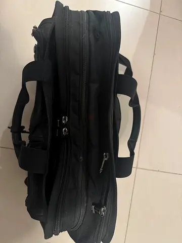 Black expandable Tumi laptop briefcase with multiple compartments