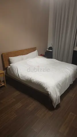 Wooden queen bed frame with rattan headboard and matress included - good condition
