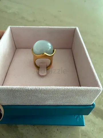 Gold-tone ring with large white moonstone-like cabochon - size 7