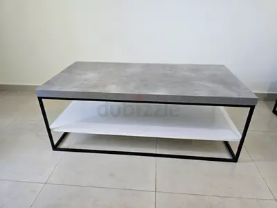 Modern rectangular coffee table with concrete-look top and lower shelf