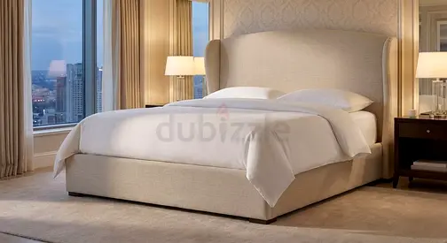 Beige upholstered double bed with headboard -