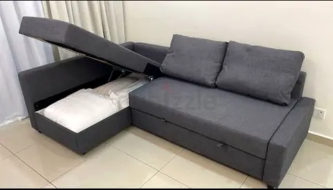 Grey L-shaped sofa bed with storage — good condition