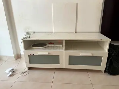 Low white TV cabinet with storage drawers and glass fronts