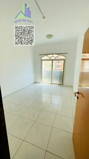 Affordable one-bedroom apartment for annual rent in Ajman Corniche, featuring a large living room, b