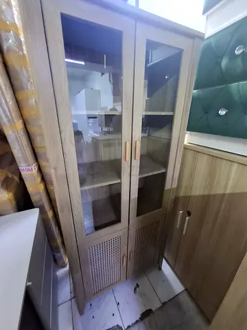 Tall wooden display cabinet with glass doors - good condition