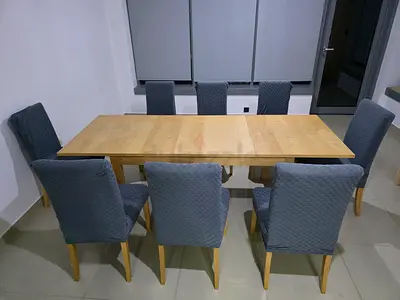 IKEA solid wood extendable dining table with 8 upholstered chairs