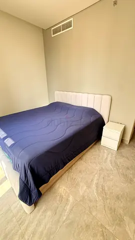 King storage bed with hydraulic lift - light wood frame and upholstered headboard