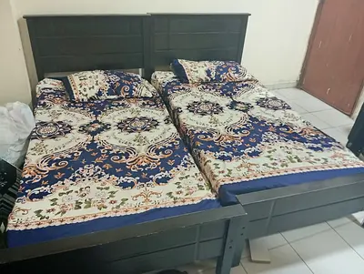 Two single wooden beds with headboards - dark finish, ready to use.       One has a small damage
