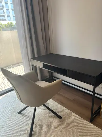 Minimalist black writing desk with swivel armchair