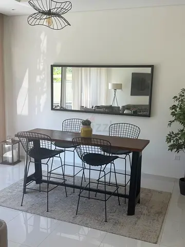 Wood bar table with 4 wire chairs and neutral rug - good condition
