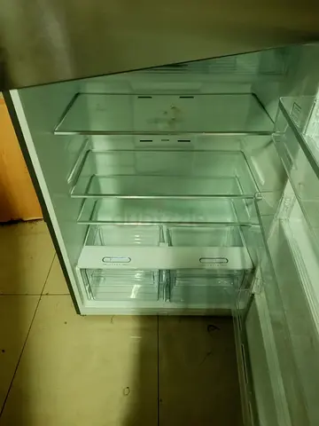 Used single-door refrigerator in good working condition - shelves and drawers included