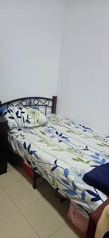 Double metal frame bed with mattress and bedding