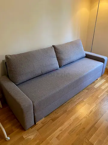 Three-seater grey fabric sofa bed in good condition