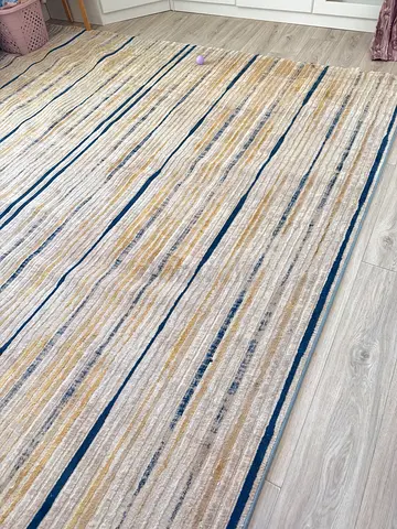 Striped beige and blue area rug - good condition