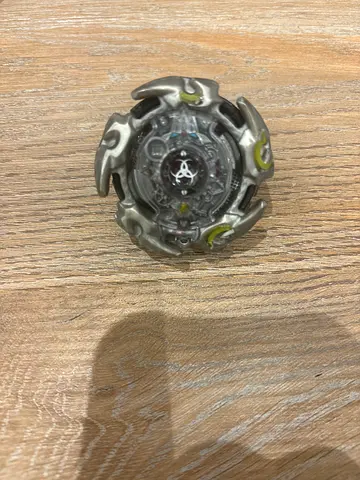 Used Beyblade-style spinning top toy (single piece) - good condition