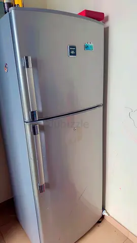 Used silver double-door refrigerator - good working condition