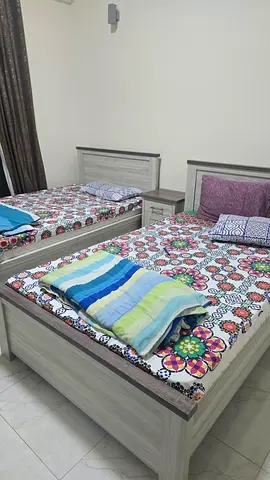 Pair of single beds with mattresses, side table and dresser- light wood finish