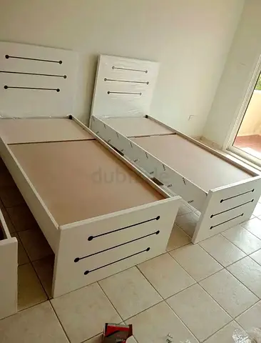 Two single white wooden beds - good condition, ready to assemble