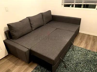 Grey fabric L-shaped sofa bed with storage - good condition