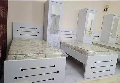 Pair of Single White Beds with Mattresses and Mirrored Wardrobes