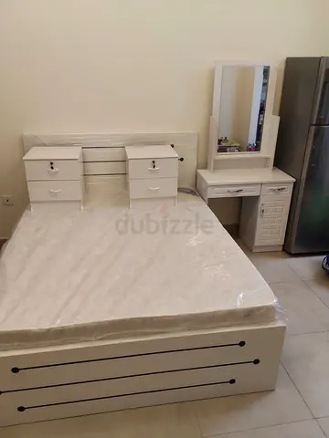 White double bed with headboard, mattress, two nightstands and dressing table