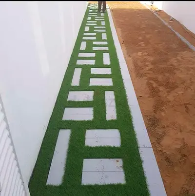 Outdoor artificial grass pathway panels with geometric concrete insets
