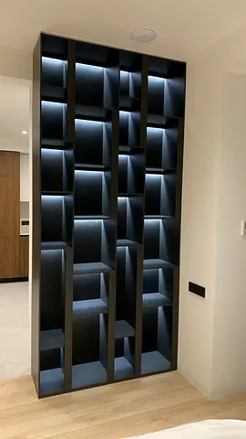 Tall modern built-in display shelving unit with LED lighting