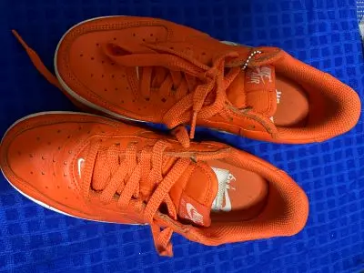Orange Nike low-top sneakers, lightly used, size available