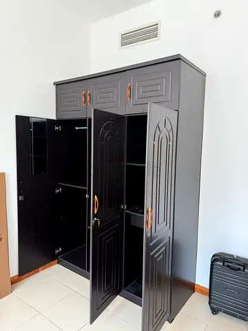 Dark wood freestanding wardrobe with shelves and drawers