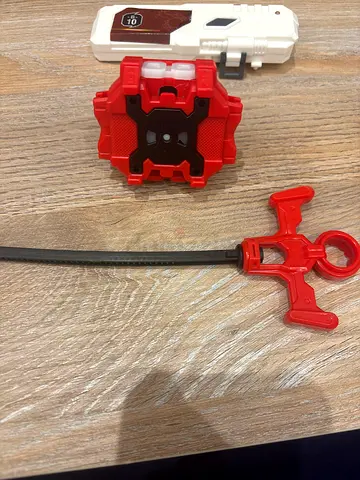 Set of toy launcher, spinner and grip accessory (used)