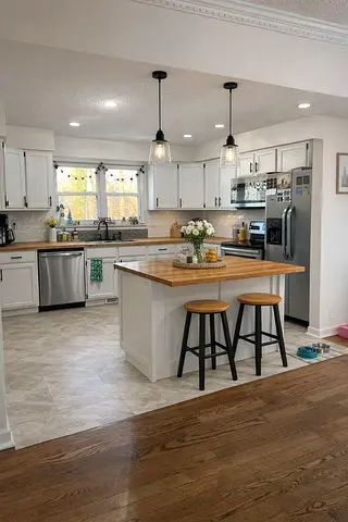 White kitchen island with wooden countertop