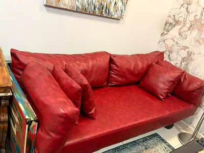 Red leather 3-seater sofa in good condition
