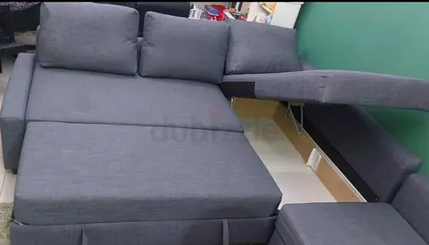 Grey L-shaped sofa bed with storage - convertible, good condition
