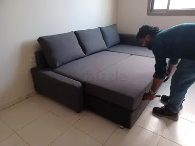 Grey L-shaped sofa bed with storage - good condition