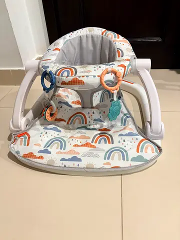 Fisher price portable baby seat with toy rings, gently used.