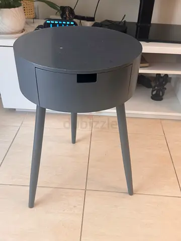 Round grey side table with hidden storage