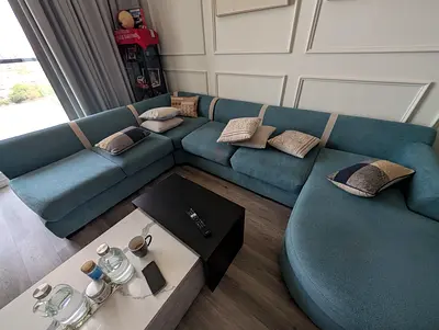 Large L-shaped sectional sofa in teal blue — comfortable modern design