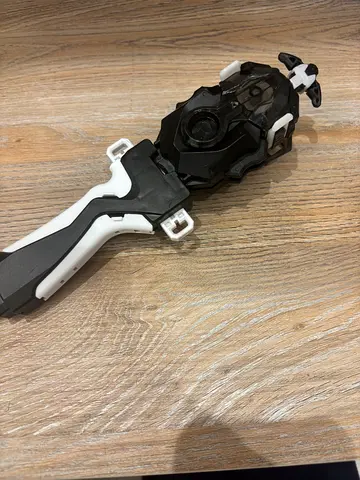 Beyblade-style ripcord launcher (black & white) - used